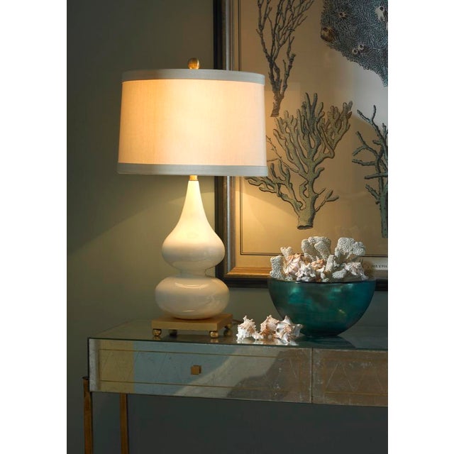 The sleek double gourd shape gives visual intrigue to this 28" table lamp. The antique gold leaf base emits a soft warm...