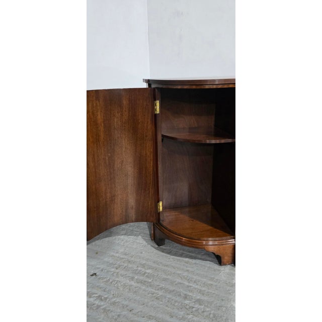 Top quality bowed sideboard of small proportions, drawers to the centre with brass ring handles, bowed doors wither side...