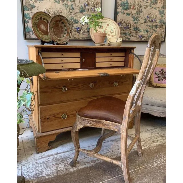 A charming and more unusual C19th Swedish fall front pine bureau on bracket feet. The top drawer fall front reveals an...