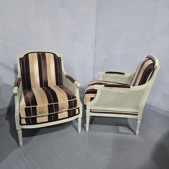 A very nice pair of French bergere armchairs, paint fiinish, with brown and cream upholstery, seperate seat cushion, very...