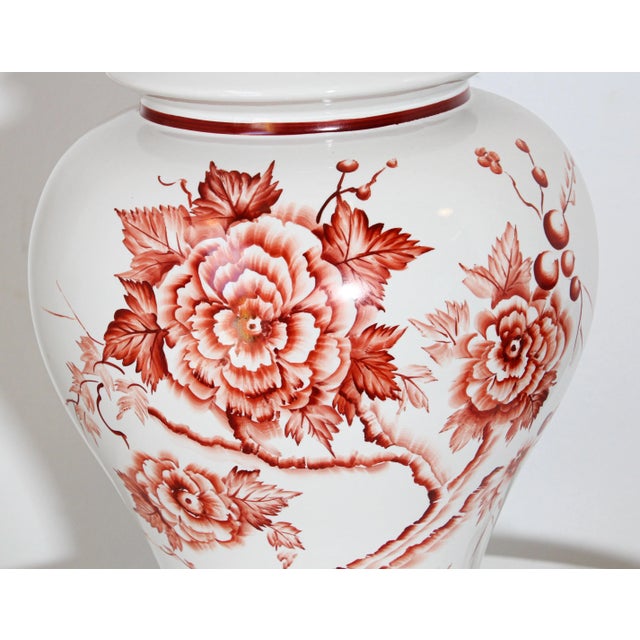 Vintage Chinese table lamp made from a white porcelain urn painted with a floral red roses design around mounted on a...