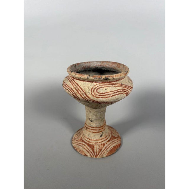 Globular terracotta vases on feet from Ban Chiang . Curvilinear ochre decoration on beige slip . Thailand. Ban Chiang...