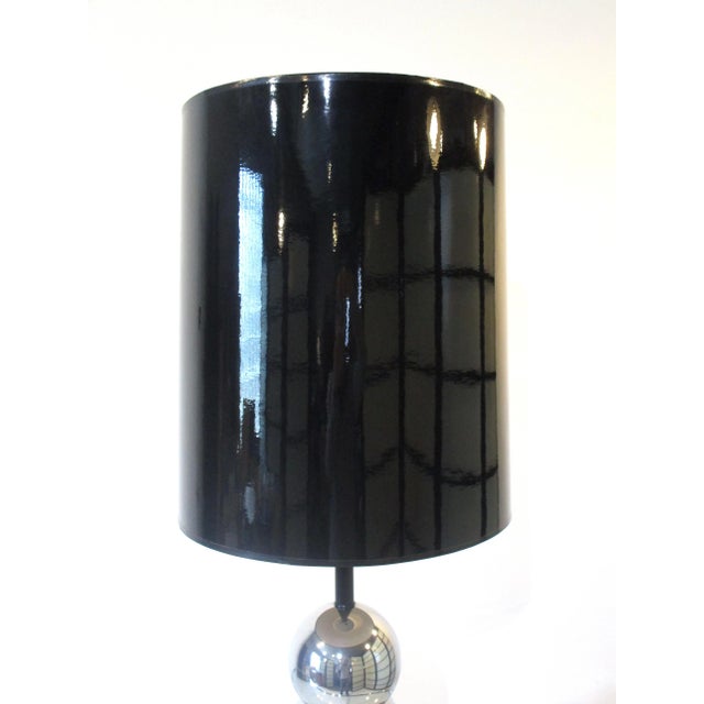 A very well crafted stacking ball or caterpillar chrome table lamp with the original glossy black shade . The lamp base...