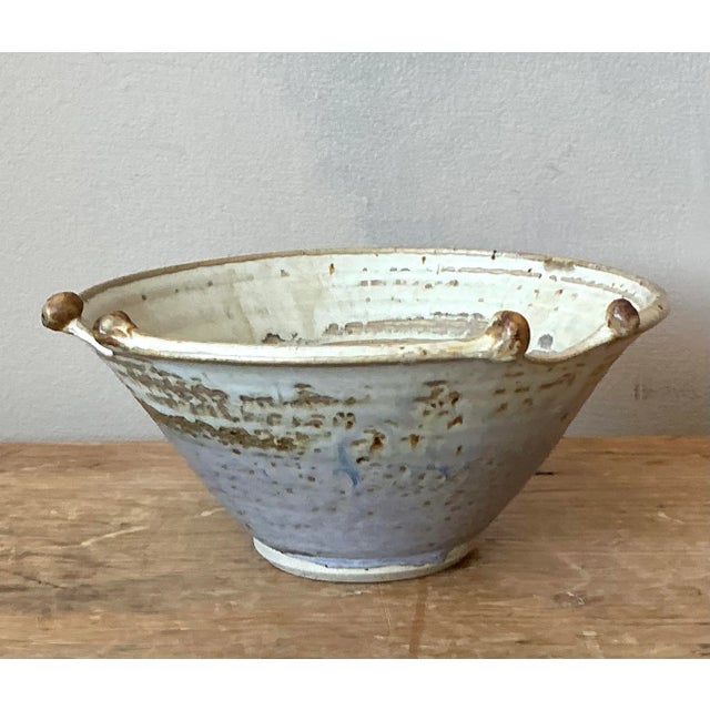 This unique studio pottery bowl, signed and dated "W. Wicks '03," is a compelling example of contemporary artisan ceramics...