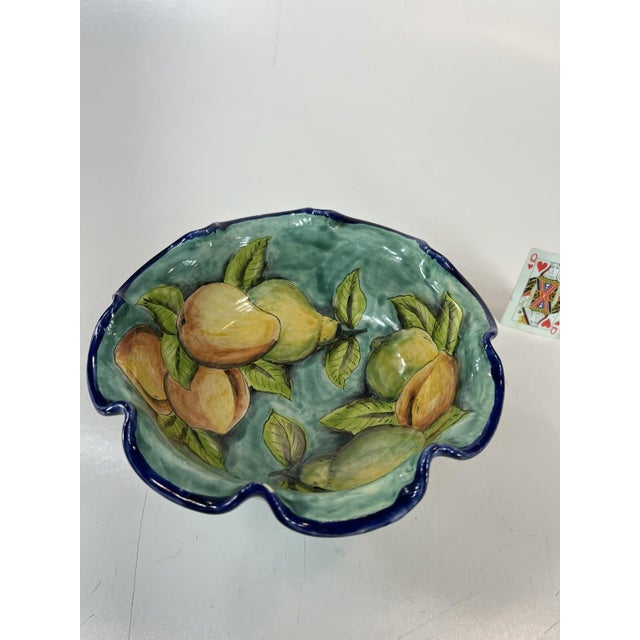 This colorful Majolica of Santa Rosa hand painted imported footed fruit bowl. It stands at 6.1/4"” tall. 9.3/4" across...
