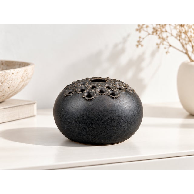Sculptural Ikebana vase by Danish ceramicist Aage Würtz. The spherical design and the extraordinary, volcanic-like...