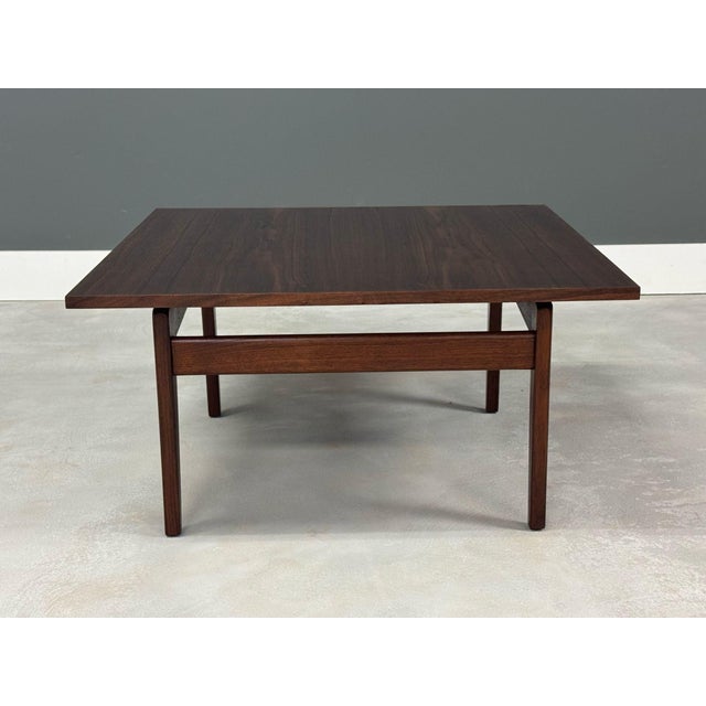 A mid century modern walnut square coffee table designed by Jens Risom. Professionally refinished. Unmarked. Made in USA....
