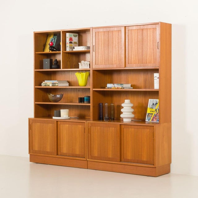 This large danish mid-century modern bookcase by poul hundevad, crafted in the 1970s, is a timeless example of...