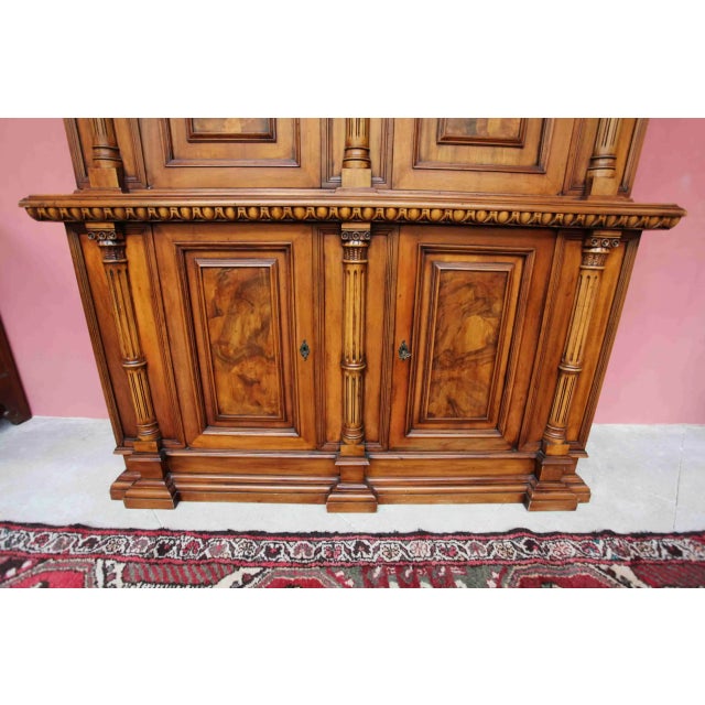 Beautiful cabinet decorated with hand carving, fluted columns, cornice molding and spice rack. The cabinet is two-part....
