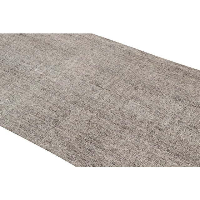 Originating from Turkey in 1960, this vintage wool Kilim runner is flat-woven in high-quality wool with subtly...