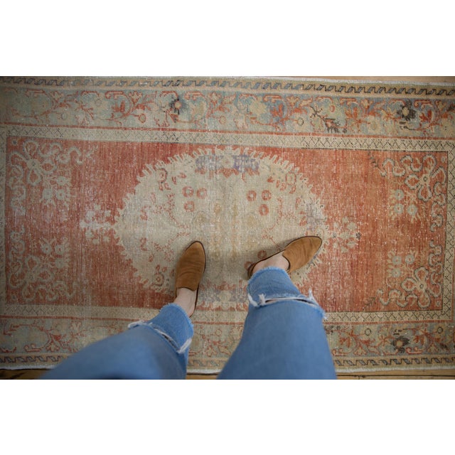 :: Cameo shaped center medallion atop an open field with ribboned corner spandrel design motif wrapped by a meandering...