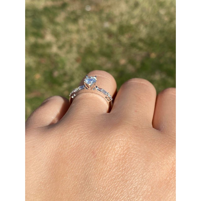 The One: Natural Diamond Engagement Ring in White Gold. This elegant ring showcases a stunning 0.64 carat round brilliant-...