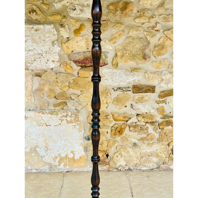 Mid-century, vintage turned wood floor lamp circa 1950s. Piece is made of wood with a nice rich dark brown oak finish and...