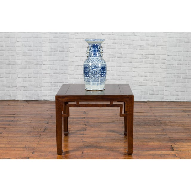 A Chinese Qing Dynasty period square-shaped side table from the 19th century, with horsehoof extremities. We currently...