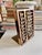 A distinctive vintage abacus bookend crafted from warm-toned wood with aged brass accents and movable wooden counting...