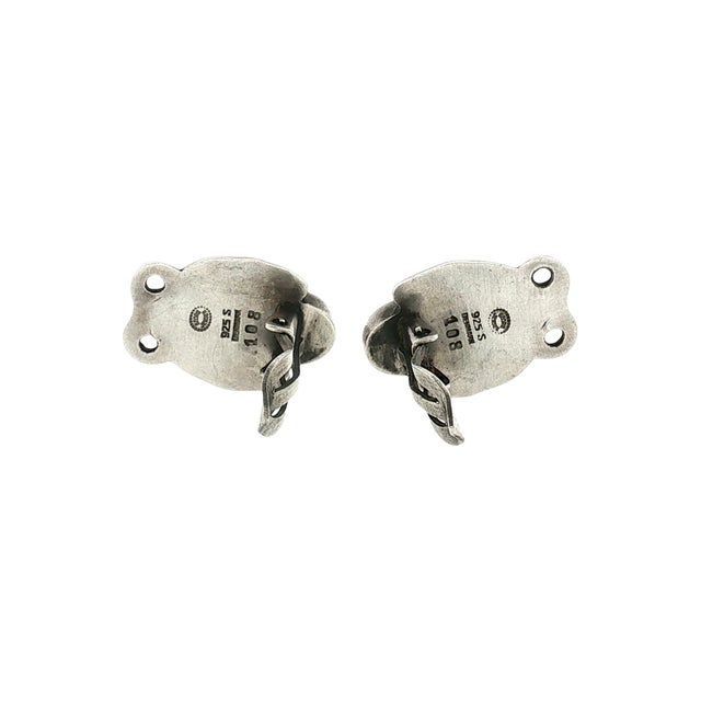 A pair of mid-century Georg Jensen #108 sterling silver clip-on earrings. Features a leaf-like design with a central oval...