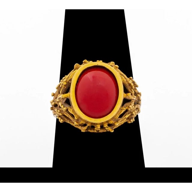 18K Yellow Gold Faux Coral Ring, decorated with one oval cabochon opaque red stone, marked: "750" with maker's mark....