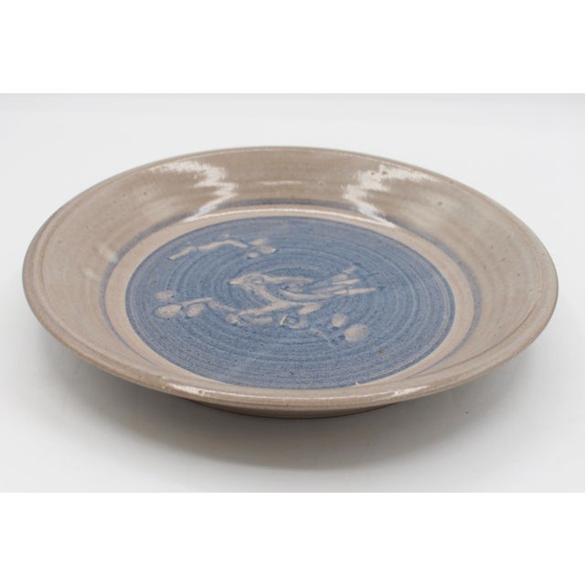 Jugtown Ware Pottery, 1978, Bird Motif Pie Plate. Decorated with a bird on a branch, butt to blue glaze. The mark created...