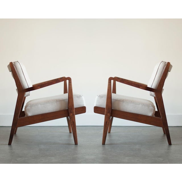 Experience the epitome of mid-century modern elegance with our fully restored walnut lounge chairs from the 1950s, a...