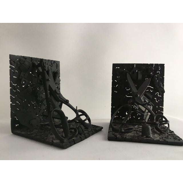 One-of-a-kind folk art metal bookends made with various found options. c. 1970's. Each has felt underneath.