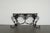 Atributed to Maitland-Smith console table features an elaborately sculpted metal base with scrolling forms, acanthus leaf...