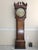 An antique oak tall case clock (or grandfather clock) with a natural highly figured wood with great patina, a distinctive...