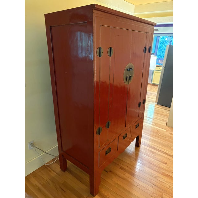 Beautiful condition 19th century Chinese Wedding Cabinet. The red laquer is a rich deep red with big brass doors and...