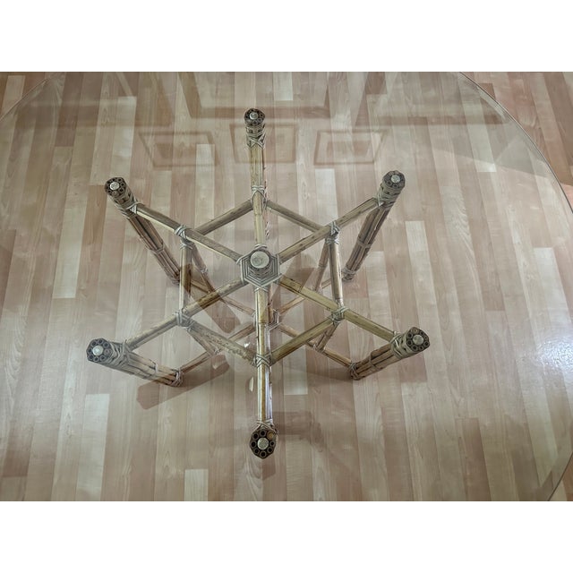 Elevate your dining space with this exceptional unmarked circular dining table attributed to McGuire, renowned for its...