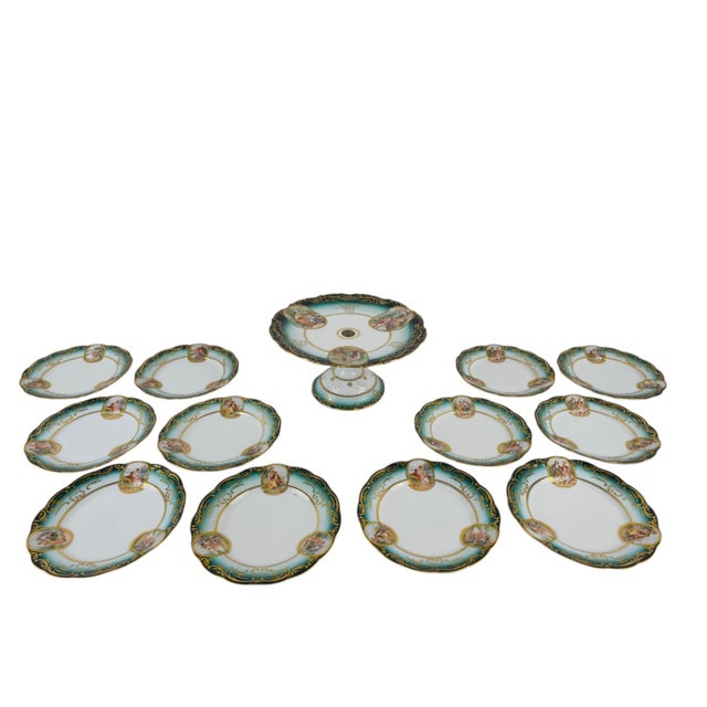A Jugendstil Viennese porcelain cake set comprising a cake stand and twelve matching plates. The pieces are decorated with...