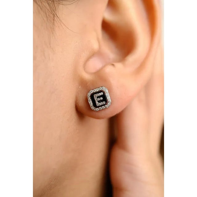 This is part of Chairish’s Fine Jewelry assortment. Diamond Studded E Initial Studs Earrings in 18K Gold to make a...