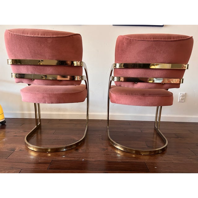 A pair of vintage Cal-Style Furniture Mfg. Co. cantilever armchairs from the 1980s. The sculptural brass-plated frames...