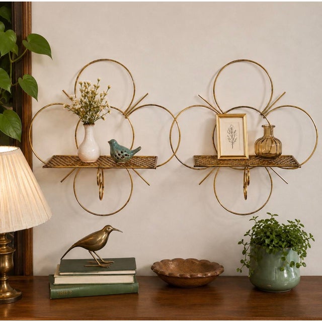 Charming pair of vintage gold-tone wire wall shelves dating to approximately the 1950s–1960s. These sculptural shelves...