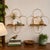 Charming pair of vintage gold-tone wire wall shelves dating to approximately the 1950s–1960s. These sculptural shelves...