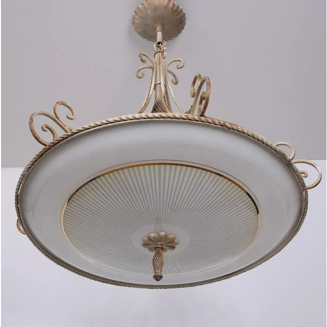 Very nice and attractive chandelier. Wrought Iron base comes with a curved glass shade, on the shade gold lining. Three...