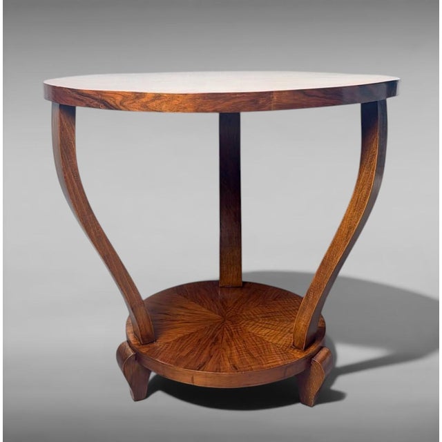 Refined and elegant Italian Art Deco coffee table crafted in walnut. Characterized by clean, harmonious lines, it features...