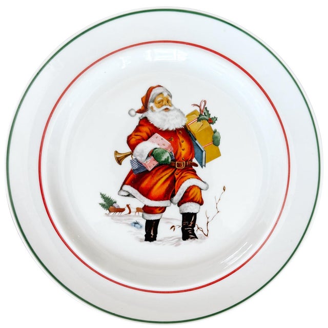 A set of six beautiful 1950s Bavarian salad plates featuring Santa walking in the snow carrying presents. His sleigh and...