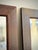 Striking pair of vintage solid wood mirrors featuring hand-painted parcel-gilt decoration over a rich reddish-brown...