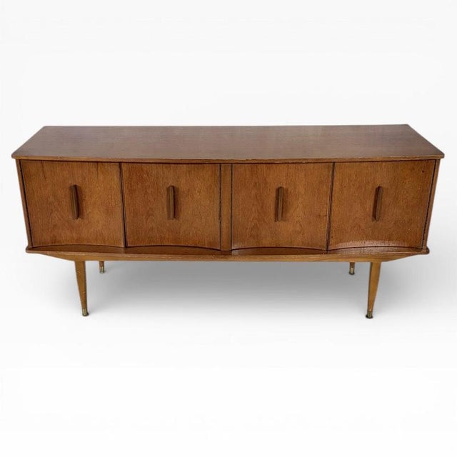 A beautifully proportioned mid-century teak sideboard by Argosy Furniture, showcasing classic British 1960s design. The...