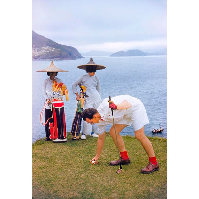 Golfing In Hong Kong by Toni Frissell A golfer prepares to tee off on a coastal course in Hong Kong, 1959. (Photo by Toni...