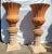 A stunning pair of large Italian "Ref Impruneta" terracotta fluted urns featuring scallop edges and reeded bodies. This...