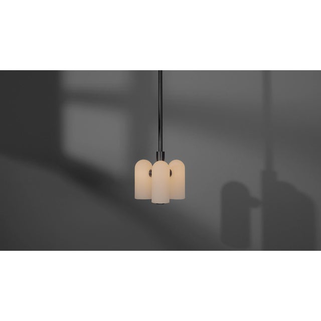 Influenced by the fashions of the future, in large and small scale. A honeycomb structure of three glass shades suggests...