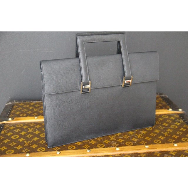 Rare and sophisticated, this Hermès briefcase in black Epsom leather is distinguished by its clean, architectural lines...