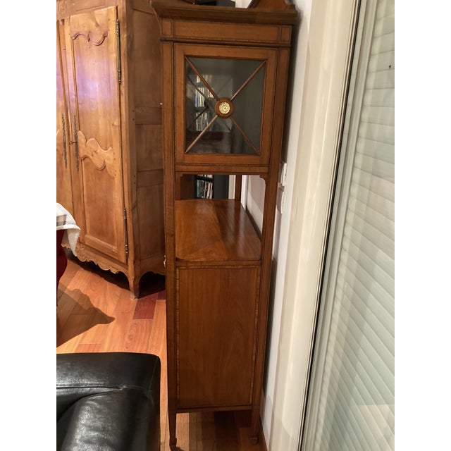 A superb and elegant fruitwood display cabinet, a piece of character that combines functionality and refinement. Likely...