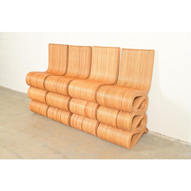A gorgeous set of four sculptural Organic Modern pencil reed rattan bar stools In the manner of Gabriella Crespi Italy,...