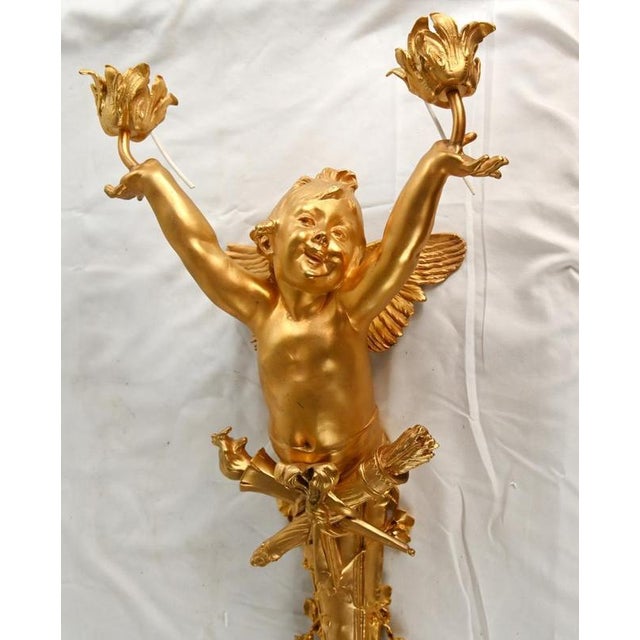 Elegant pair of french gilt bronze wall sconces in the louis xvi revival taste each modelled as a winged cherub with...