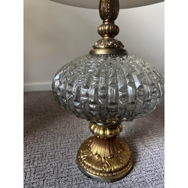 Beautiful vintage table lamp featuring a cut smokey glass body paired with a substantial brass base and detailing. The...