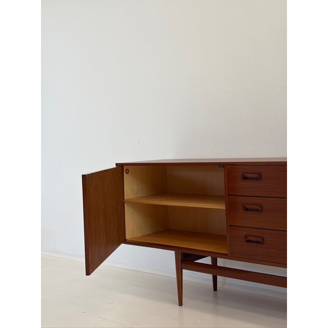 Vintage Teak Sideboard from Musterring, 1970s, in Flawless conditions. Designed 1970 to 1979 This piece has an attribution...