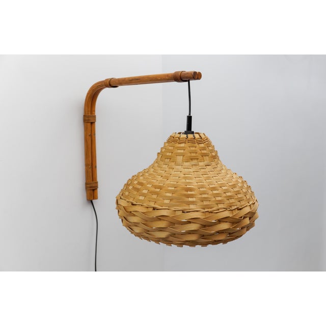 Mid-Century Modern wall lamp Bamboo and rattan wickerwork, 1960s Italy The lamp is executed with 1x E27 Edison screw fit...