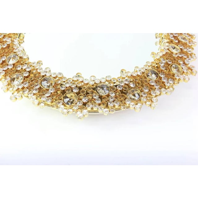 A wonderful and high quality gilded wall mirror by palwa (palme & walter), germany, 1970s. It is made of a 24-carat gold-...