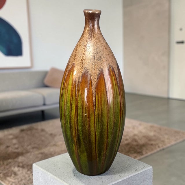This 16'' high Mid-Century Modern Earth Tone Glazed Pottery vase is a stunning decorative piece that adds a touch of retro...